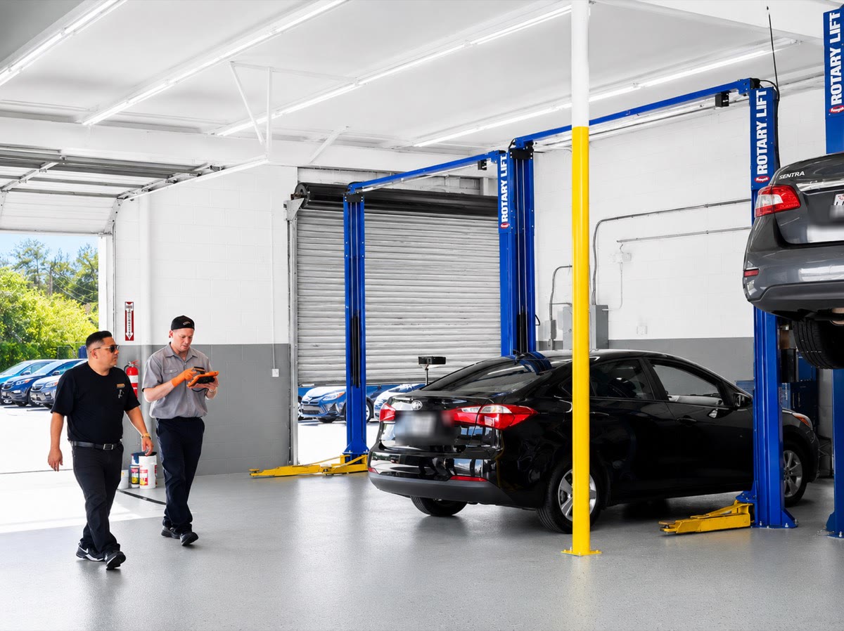 ASE certified technicians working in the service bay at Meineke Bear Creek